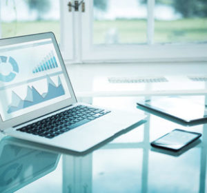 Laptop on table with smart phone and tablet