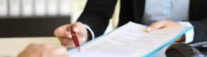 Executive hands indicating where to sign contract