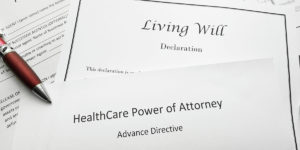 Pen on top of papers including Living Will Declaration, HealthCare Power of Attorney Advance Directive
